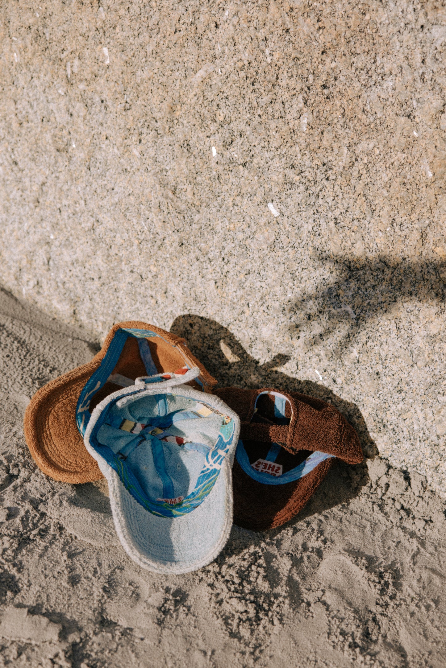Upcycled Towel Hats sitting on the sand